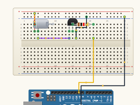 Breadboard view. A DC motor switched by an NPN transistor: motor from the battery to the collector, emitter to ground, base driven from D9 through a 1 kilohm resistor