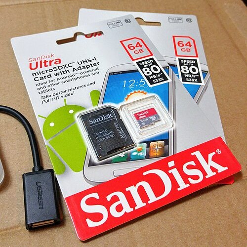 A microSD memory card still in its packet, labelled 64 GB