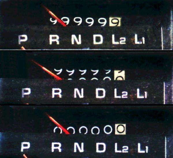 Three frames of a car mileage counter rolling from 99999.9 to 00000.0