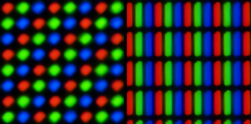 Extreme close-up of two screens showing rows of tiny red, green and blue lights