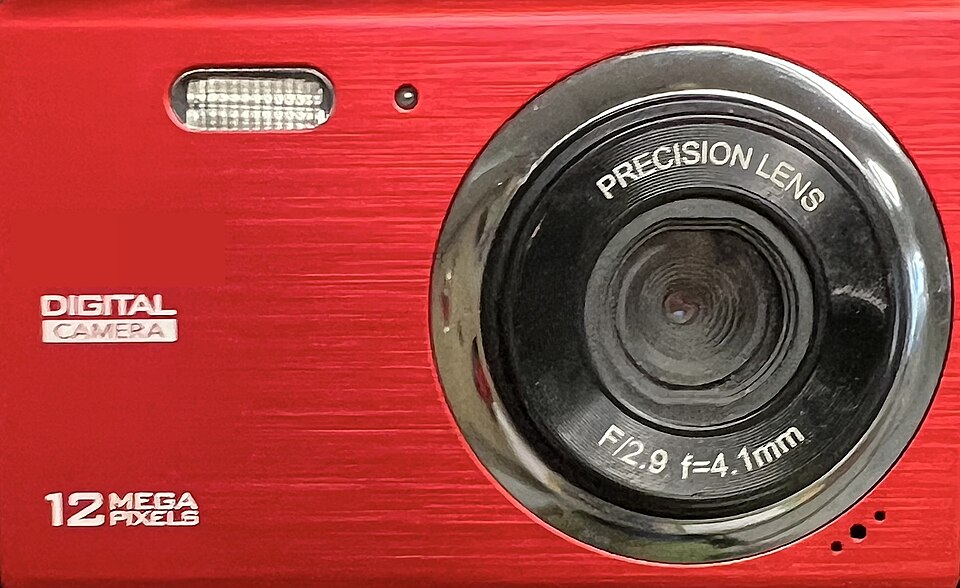 The front of a red compact digital camera showing the lens, the flash and a 12 megapixels label