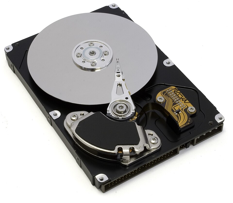 An opened hard disk drive with its read-write arm over the platter