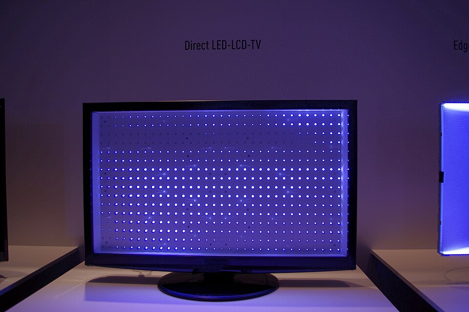 An LCD TV with its panel removed, showing a grid of glowing blue-white LEDs