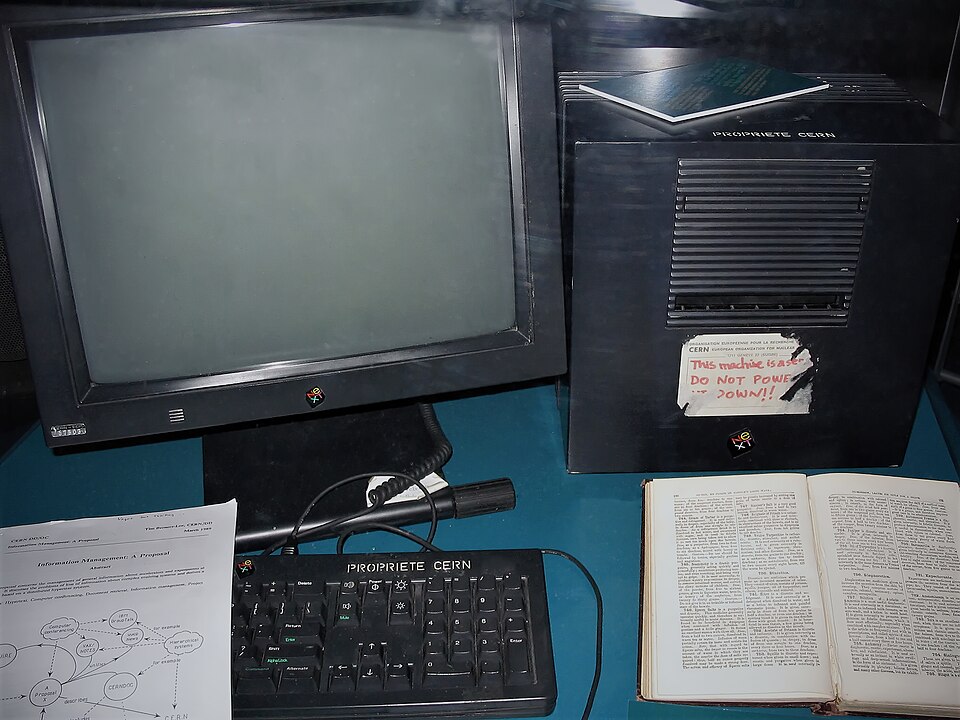 A black NeXT cube computer with a handwritten note on the case, the first web server