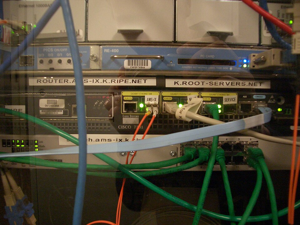 Rack-mounted server hardware labelled K.ROOT-SERVERS.NET with network cables attached