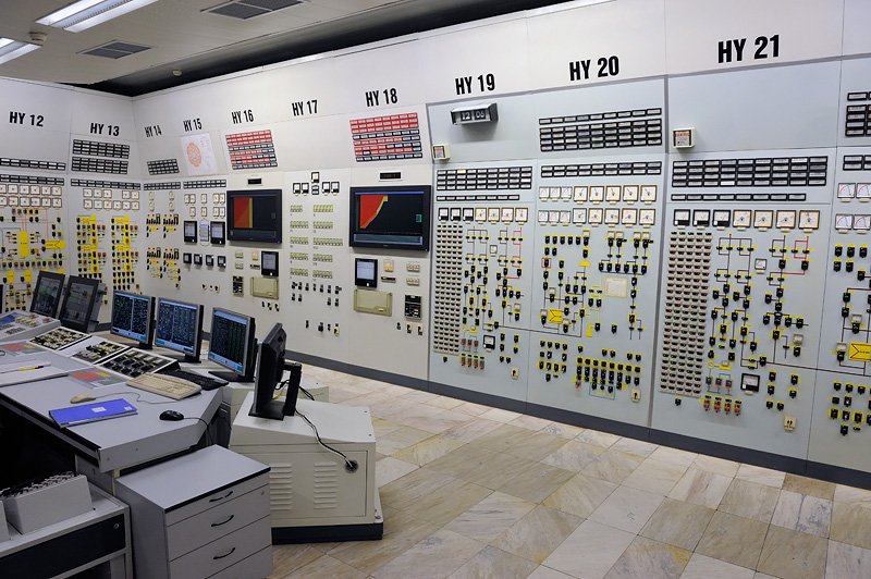 A nuclear power station control room with wall-sized panels of dials, indicator lights and computer screens