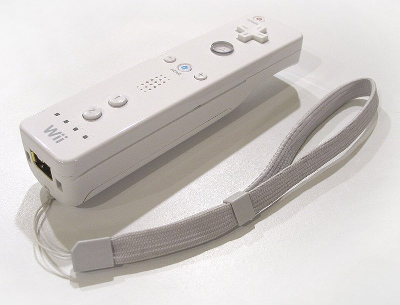 A white motion-sensing games controller with a wrist strap