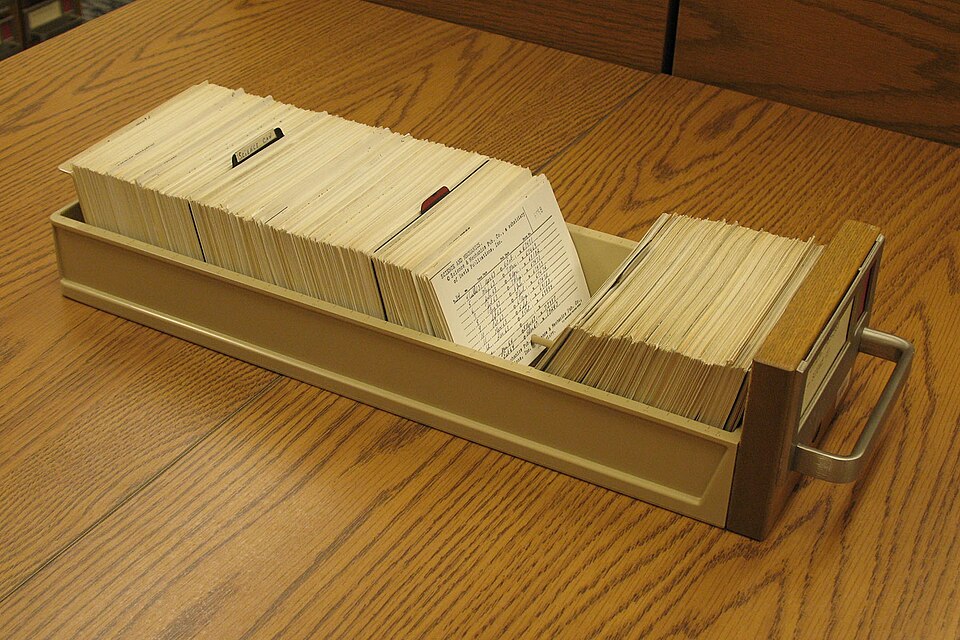 A drawer from a library card catalogue, packed with index cards